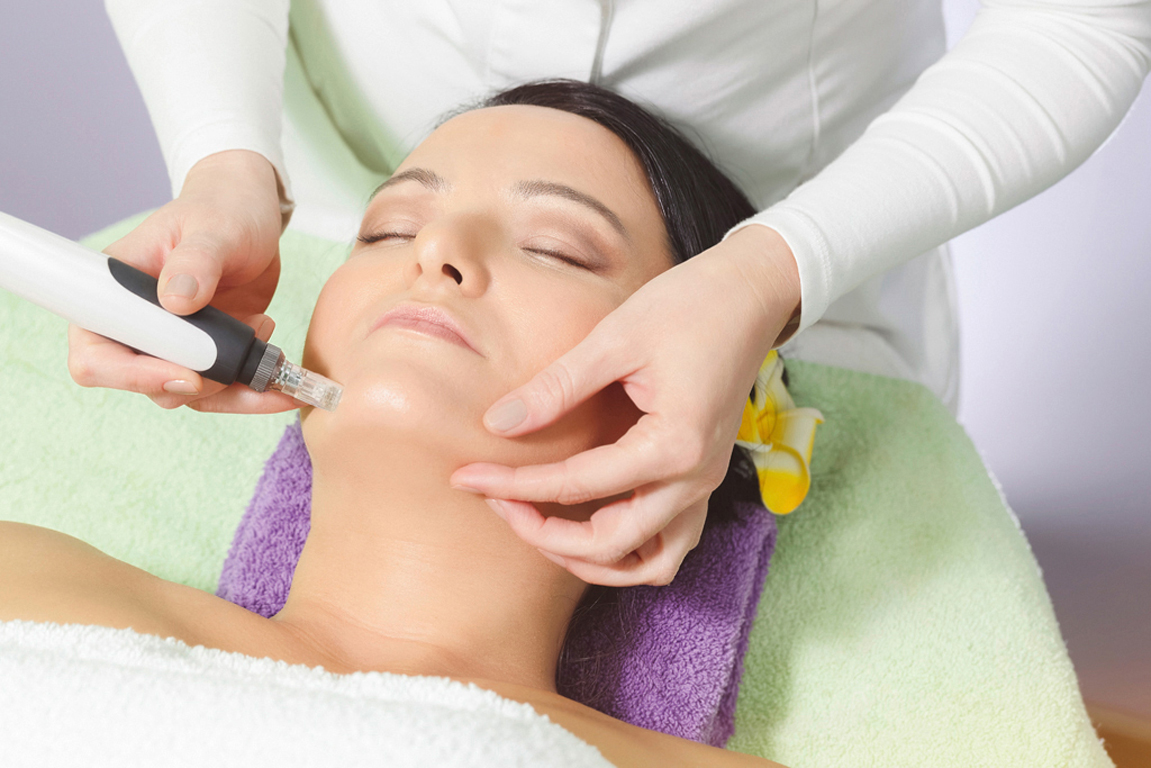 Woman having mesotherapy facial treatment at beauty salon. Close